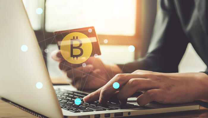 Common Issues When Buying Bitcoin with Credit Card 1 - Incryptocoin Person using a laptop to make a secure Bitcoin purchase with credit card, symbolizing how to Buy Bitcoin with Credit Card.