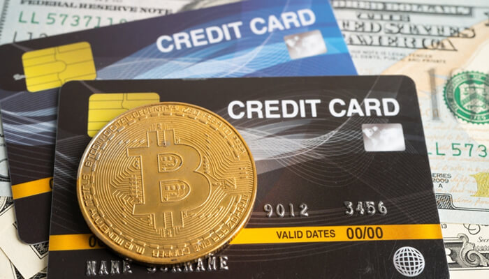 Credit cards and a Bitcoin coin representing the process to Buy Bitcoin with Credit Card.