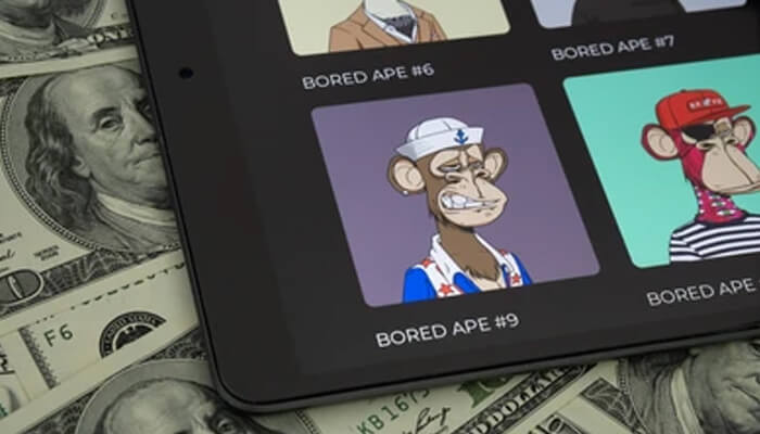 expen 1 - Incryptocoin Tablet displaying Bored Ape collection beside dollar bills representing most expensive NFT sales in the crypto market.